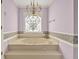 Close up of Jacuzzi tub in Primary bathroom with stained glass window at 3200 Country Club Nw Ct, Kennesaw, GA 30144