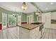 Spacious kitchen with white cabinets, granite countertops, an island with cooktop, and stainless appliances at 3200 Country Club Nw Ct, Kennesaw, GA 30144
