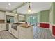 Spacious kitchen with island cooktop, stainless appliances, granite counters and white cabinets, and tile floors at 3200 Country Club Nw Ct, Kennesaw, GA 30144