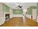 Spacious living room with a fireplace, hardwood floors, and custom built-in shelving at 3200 Country Club Nw Ct, Kennesaw, GA 30144
