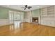 Cozy living room featuring a brick fireplace, built-in shelves, and elegant French doors at 3200 Country Club Nw Ct, Kennesaw, GA 30144