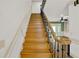 Elegant staircase with wooden steps and ornate iron railing leading to the second floor at 3200 Country Club Nw Ct, Kennesaw, GA 30144