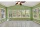 Bright sunroom featuring tile flooring, a vaulted ceiling, and multiple windows with wooded views at 3200 Country Club Nw Ct, Kennesaw, GA 30144