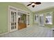 Bright sunroom with many windows and views of the wooded yard, with french doors to the main house at 3200 Country Club Nw Ct, Kennesaw, GA 30144