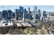 Stunning aerial view of the city skyline with modern buildings surrounded by lush greenery and mature trees at 273 12Th Ne St # 114, Atlanta, GA 30309