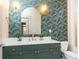 Chic bathroom with bold wallpaper, quartz countertops, and gold accents throughout at 273 12Th Ne St # 114, Atlanta, GA 30309