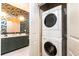 Stylish bathroom with a modern vanity, unique wallpaper, and convenient washer and dryer setup at 273 12Th Ne St # 114, Atlanta, GA 30309