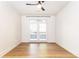 Bright bedroom featuring hardwood floors, ceiling fan, and access to an outdoor patio with natural light at 273 12Th Ne St # 114, Atlanta, GA 30309