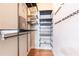 Organized walk-in closet with adjustable shelving, hanging rods, and wood flooring at 273 12Th Ne St # 114, Atlanta, GA 30309