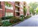 Attractive red brick apartment building with private balconies and lush, landscaped grounds at 273 12Th Ne St # 114, Atlanta, GA 30309