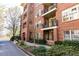 Charming brick apartment building with balconies and well-maintained landscaping at 273 12Th Ne St # 114, Atlanta, GA 30309