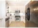 Modern kitchen with white cabinets, stainless steel appliances, quartz countertops, and tile backsplash at 273 12Th Ne St # 114, Atlanta, GA 30309