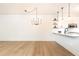 Bright kitchen featuring pendant lights, open shelving, and white cabinets at 273 12Th Ne St # 114, Atlanta, GA 30309