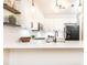 Bright kitchen features quartz countertops, white cabinets, and a black faucet at 273 12Th Ne St # 114, Atlanta, GA 30309