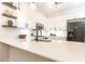 Modern kitchen with white cabinets, stainless steel appliances, quartz countertops, and floating shelves at 273 12Th Ne St # 114, Atlanta, GA 30309