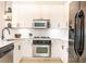 Modern kitchen with white cabinets, stainless steel appliances, quartz countertops, and tile backsplash at 273 12Th Ne St # 114, Atlanta, GA 30309