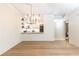 Bright living room with a modern chandelier, seating, and an open view of the updated kitchen area at 273 12Th Ne St # 114, Atlanta, GA 30309