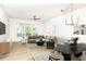 Light-filled living room with modern ceiling fan, dining area, and large windows at 273 12Th Ne St # 114, Atlanta, GA 30309