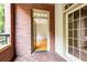 Inviting outdoor patio with brick flooring, showcasing an open doorway to a light-filled home interior at 273 12Th Ne St # 114, Atlanta, GA 30309