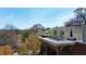 Outdoor seating area on a rooftop deck, showing a building with a park view in the background at 273 12Th Ne St # 114, Atlanta, GA 30309