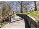 Scenic walkway featuring stone retaining wall, lush greenery, and park access at 273 12Th Ne St # 114, Atlanta, GA 30309