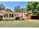 Charming home exterior featuring a sunroom, small deck, and well-maintained yard, creating a cozy outdoor living space at 4172 Whispering Forest Ct, Lilburn, GA 30047