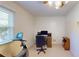 Finished basement area with great natural light features office space and exercise bike at 4172 Whispering Forest Ct, Lilburn, GA 30047
