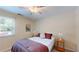 Cozy bedroom with a comfortable queen-sized bed and natural light from the window at 4172 Whispering Forest Ct, Lilburn, GA 30047