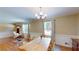 Elegant dining room with wood table, decorative lighting, and ample natural light, perfect for Gathering gatherings at 4172 Whispering Forest Ct, Lilburn, GA 30047