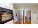 Modern kitchen featuring stainless steel refrigerator, granite countertops, and a view into the adjacent dining area at 4172 Whispering Forest Ct, Lilburn, GA 30047