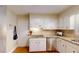 Functional kitchen with white cabinets, granite countertops, stainless steel appliances, and hardwood floors at 4172 Whispering Forest Ct, Lilburn, GA 30047