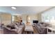 Cozy living room featuring comfortable sofas, neutral decor, and an open layout to the dining area and kitchen at 4172 Whispering Forest Ct, Lilburn, GA 30047