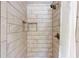Nicely tiled shower stall with built-in shampoo shelves and detachable shower head at 4172 Whispering Forest Ct, Lilburn, GA 30047