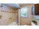 Shower-tub combination with decorative tile accents and a convenient built-in shelf at 4172 Whispering Forest Ct, Lilburn, GA 30047