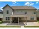 Back of the home featuring a covered porch, neutral siding, and well-manicured yard at 1645 Dahlia Dr, Cumming, GA 30040