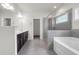 Modern bathroom with double vanity, glass-enclosed shower, and soaking tub at 1645 Dahlia Dr, Cumming, GA 30040