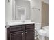 Bathroom features dark wood cabinet, white commode and a tiled shower at 1645 Dahlia Dr, Cumming, GA 30040