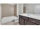 Well-lit bathroom with shower over tub and vanity with drawers at 1645 Dahlia Dr, Cumming, GA 30040