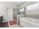 Elegant bathroom with a soaking tub and a separate glass-enclosed shower; a spa-like experience at 1645 Dahlia Dr, Cumming, GA 30040