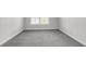 Bedroom boasts a window with blinds, gray carpet and neutral walls at 1645 Dahlia Dr, Cumming, GA 30040