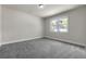 Spacious bedroom with neutral carpet, trim and a large sunny window at 1645 Dahlia Dr, Cumming, GA 30040