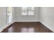 Inviting bedroom with hardwood floors and a window providing ample natural light at 1645 Dahlia Dr, Cumming, GA 30040