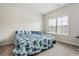Comfortable bedroom with a patterned duvet, natural light, and neutral tones creating a relaxing space at 1645 Dahlia Dr, Cumming, GA 30040