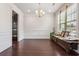 Formal dining room featuring hardwood floors, wainscoting, and a view of the kitchen at 1645 Dahlia Dr, Cumming, GA 30040