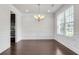 Formal dining area with hardwood floors, picture-frame molding, chandelier, and natural light at 1645 Dahlia Dr, Cumming, GA 30040