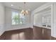 Bright dining area with hardwood floors, wainscoting, and large windows providing natural light at 1645 Dahlia Dr, Cumming, GA 30040
