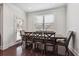 Elegant dining room with dark wood table and chairs beneath a window with natural light at 1645 Dahlia Dr, Cumming, GA 30040