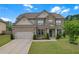 Charming brick two-story home with a well-manicured lawn, attached garage, and tasteful landscaping at 1645 Dahlia Dr, Cumming, GA 30040