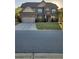 Well maintained two-story brick home with attached two-car garage, green lawn, and professional landscaping at 1645 Dahlia Dr, Cumming, GA 30040