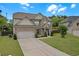 Attractive two-story house featuring a well-maintained lawn, an attached garage, and lush landscaping at 1645 Dahlia Dr, Cumming, GA 30040
